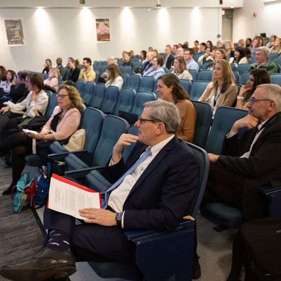 Kenneth Lutchen seated in the front row of the auditorium for the Keynote