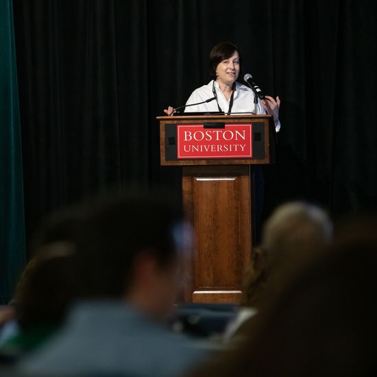 Lilach Mollick is at the podium giving a Keynote Address