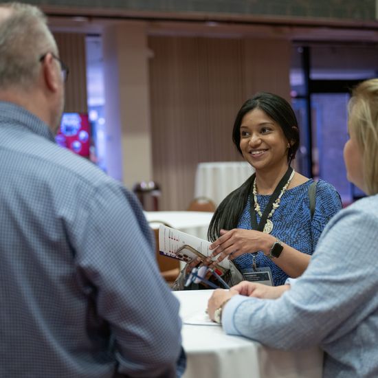 DL&I staff Annwesa Dasgupta, Linda Nulty, and Bob Heim gather at a table during the Faculty Forum.