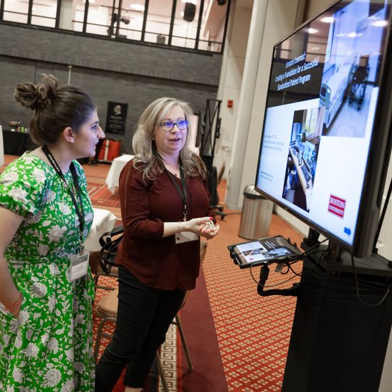 An attendee is visiting an e-poster presentation.