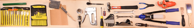 selection of the hand tools in silab (from left to right): long hole bits, punches, sandpaper, hole cutters, large stapler, screwdrivers, socket and allen wrenches, hammer, planer, files, pipe cutter, riveter, o-ring attaching tool, paint scraper, and a paint brush 