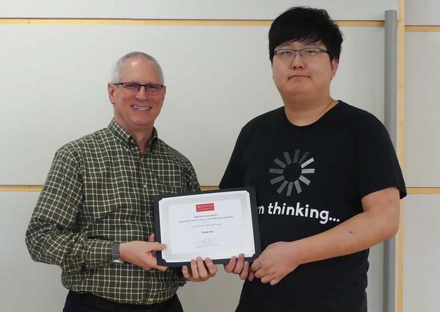 ECE Chair W. Clem Karl presents Yuan Sui (MS'23) with the 2023 CE Dissertation Award.