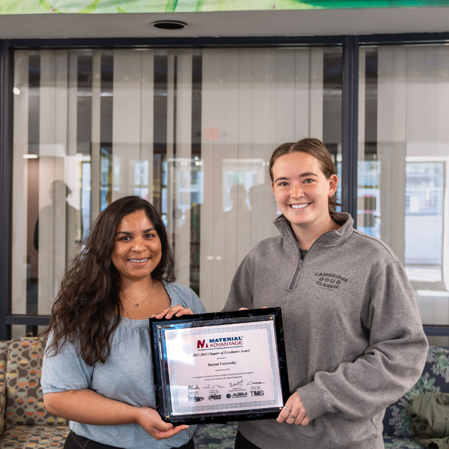 Emily Ghosh and Savannah Schisler holding award