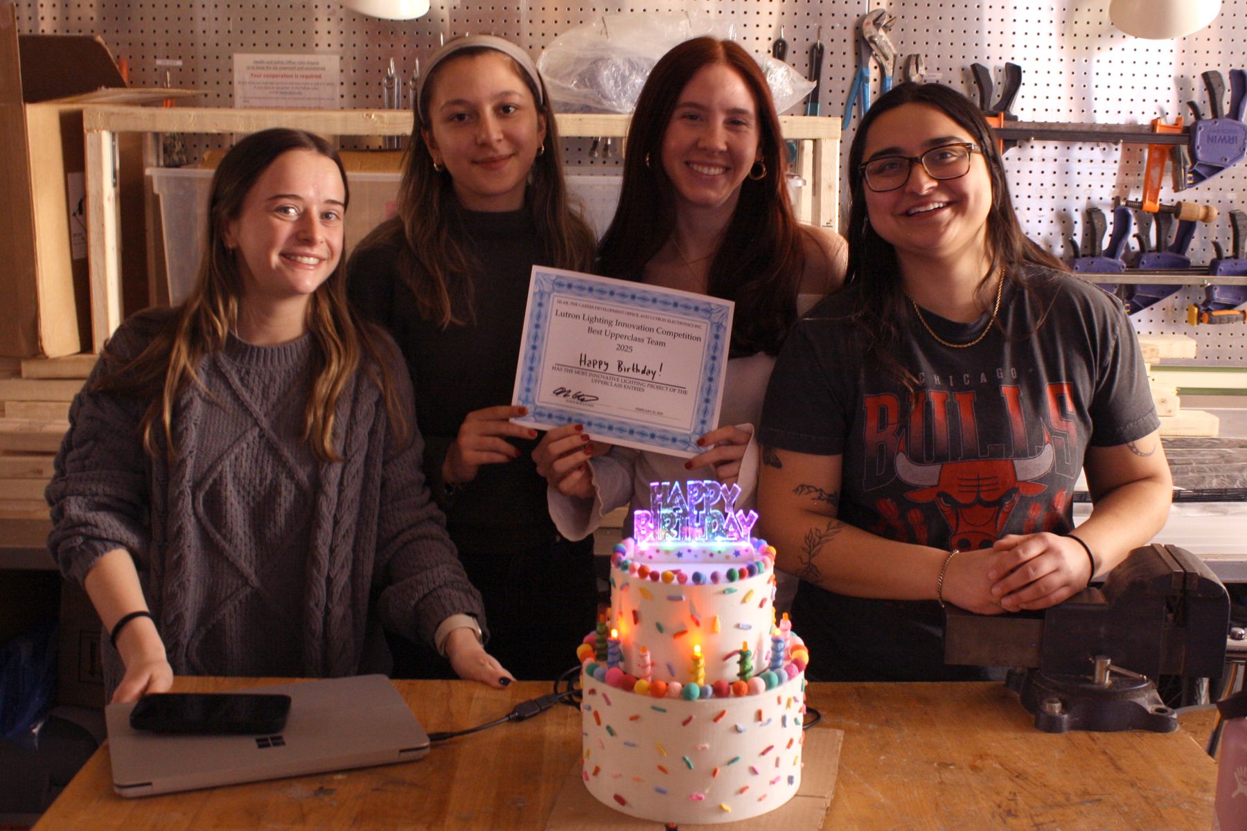 4 students who made the birthday cake with their winner certificate