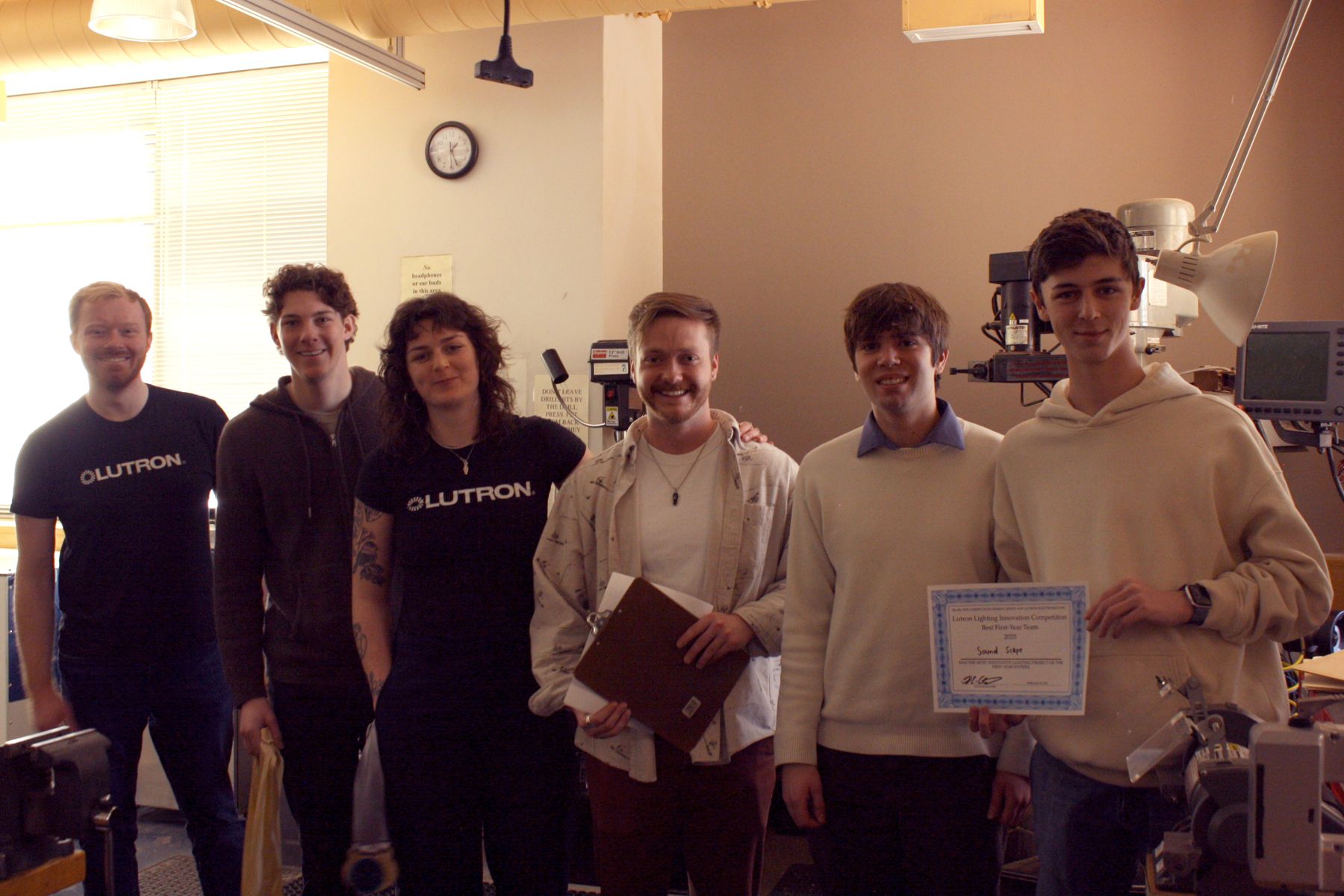 students behind the soundbar with the lutron judges and their best first year project certificate