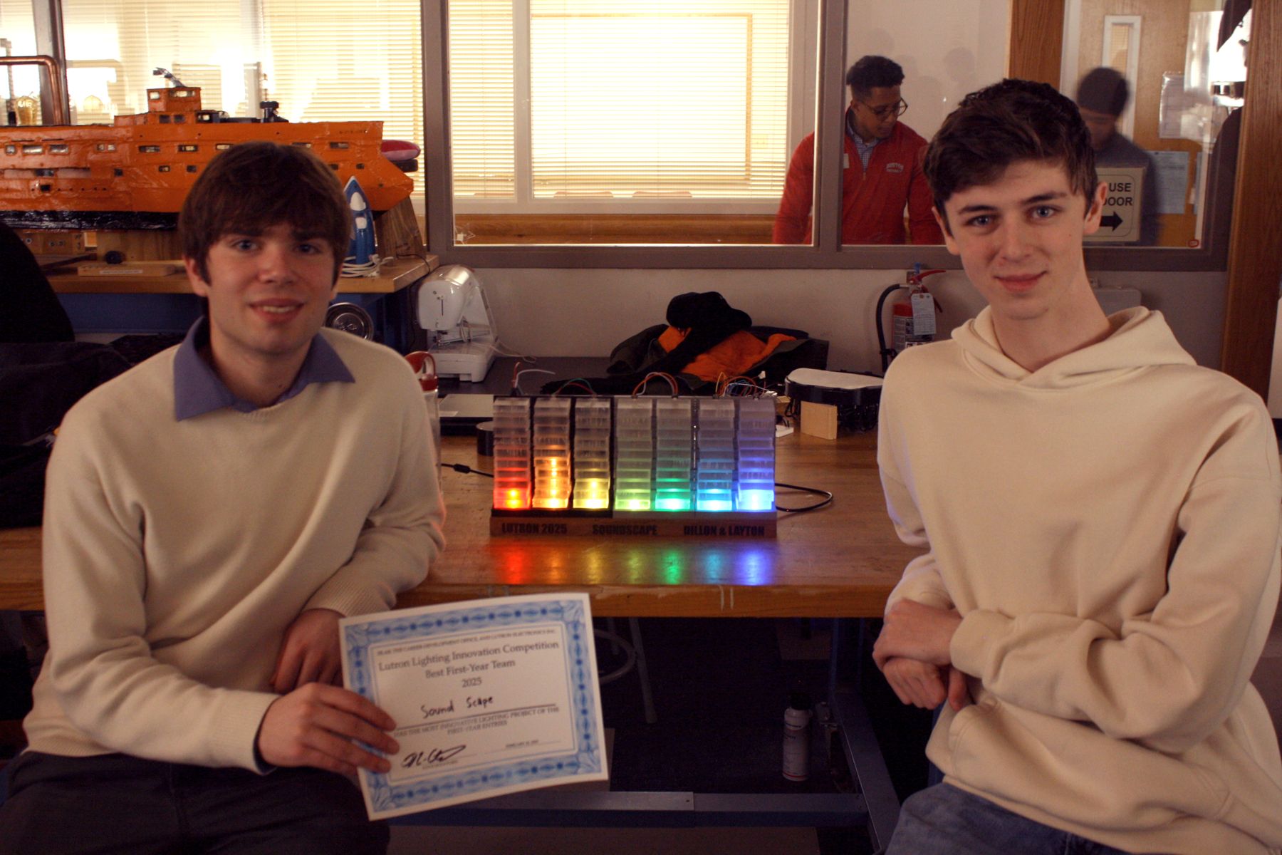 team behind the light up sound bar with their project and best first year winner certificate
