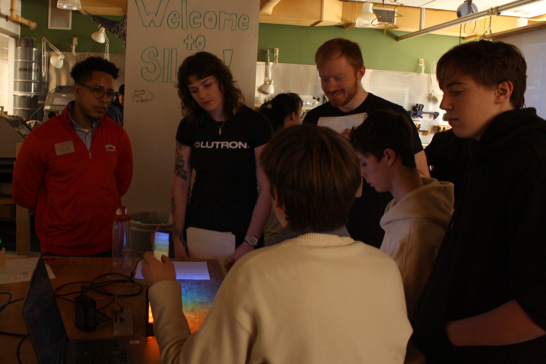 team behind the light up sound bar showing off their project to the lutron judges and CDO staff
