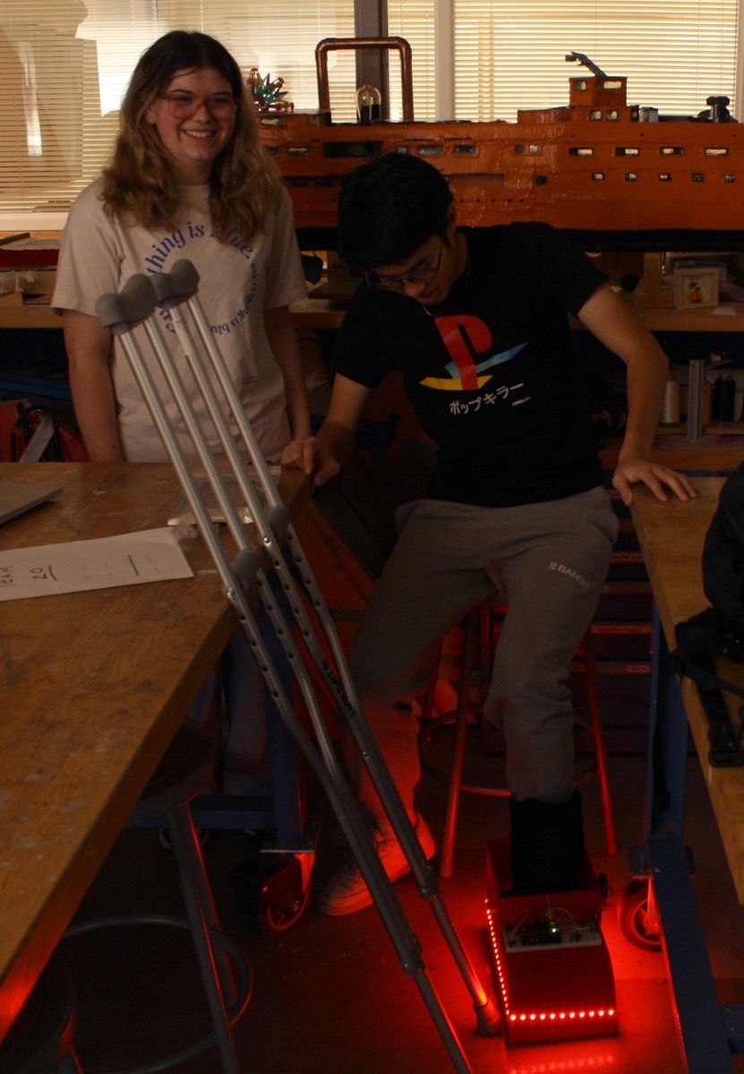 2 of the students on the team and their project, a motion sensor walking boot cover that lights up red when the injured foot touches the ground