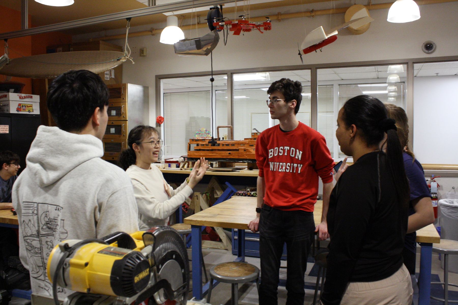 5 students in a group discussing project ideas