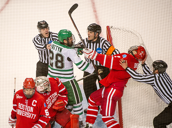Extaacurricular activity between BU's Ahti Oksanen (CAS’16) and North Dakota's Stefane Pattyn as the game begins to come to a close Thursday night at the 2015 Men's Frozen Four National Championships at TD Garden. Photo by Cydney Scott
