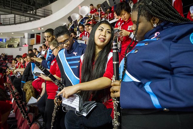 The BU Pep Band and Boston English High School Marching Band perform at the December 5 men’s hockey game at Agganis Arena: BEHS students Duel Vernet (left) and Jasmin Robinson (right) and Emily Raymond (CFA’19). Photo by Cydney Scott