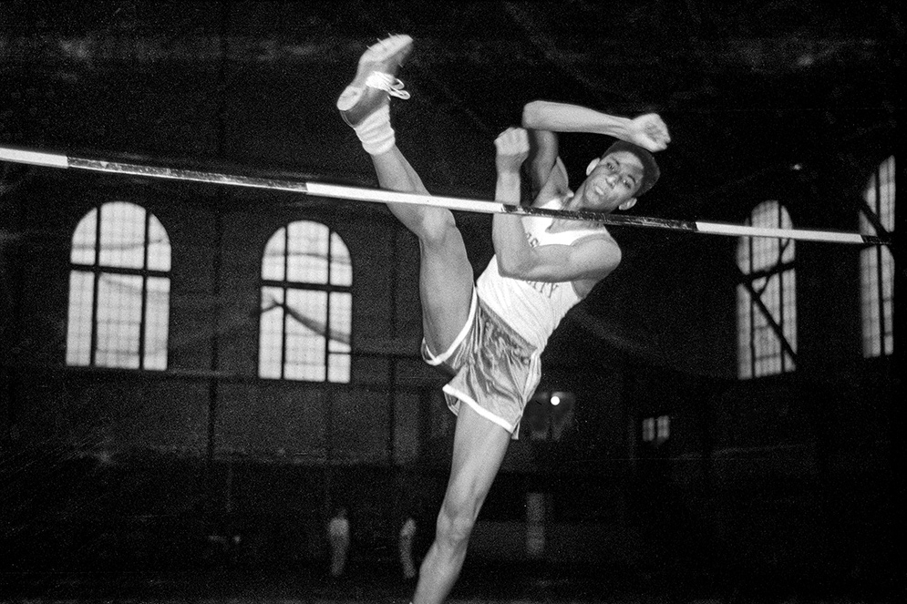 John Thomas completes a high-jump during a Boston University BU Terriers track and field vs Tufts University event in 1959