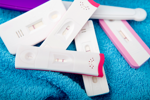 group of used pregnancy tests showing negative and positive results
