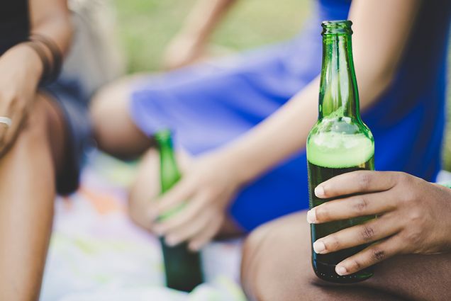 teens holding bottles of beer