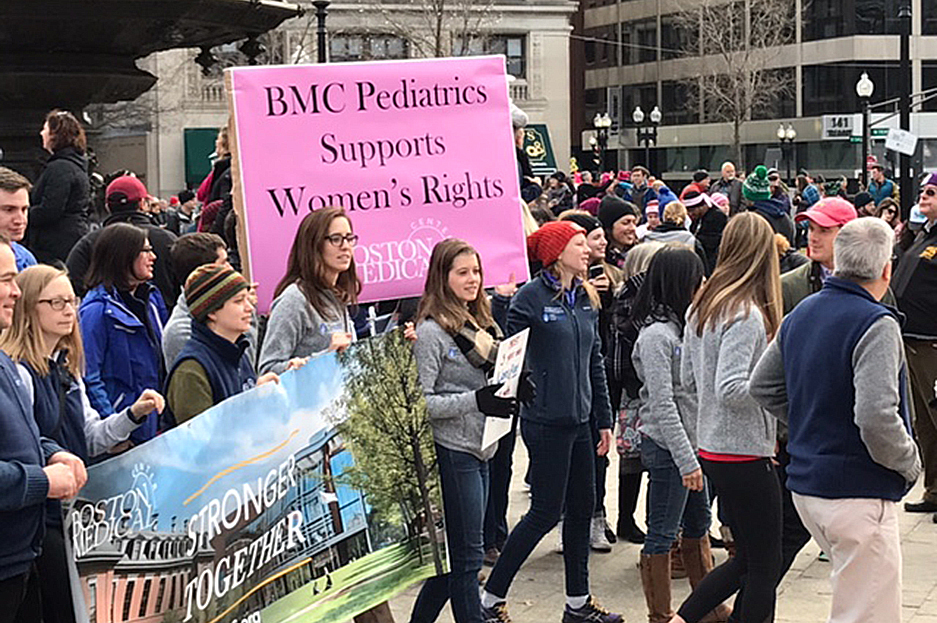 Boston Medical Center workers participate in the Boston Women's March for America, holding signs that say Boston Medical Center Stronger Together and BMC Pediatrics Supports Women's Rights