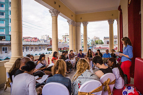 Trip coleader Julie Klinger leads a discussion on relations between Cuba and China on the balcony of Havana's Cazona 17 restaurant.