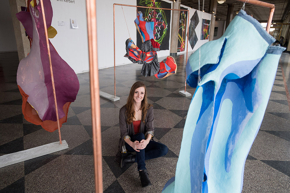 Erin Kerbert with her sculptural paintings at the 808 Gallery.