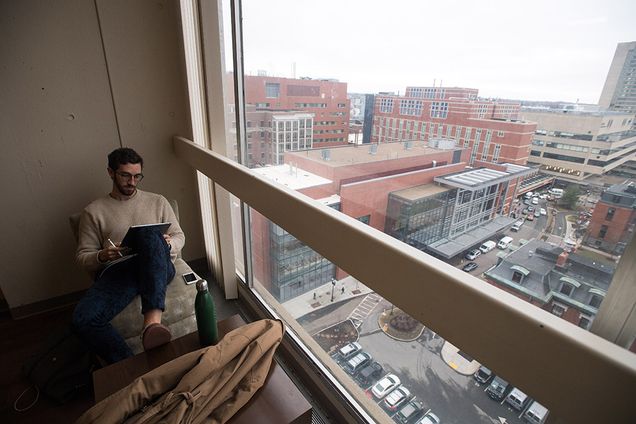 John Hayden studying by window