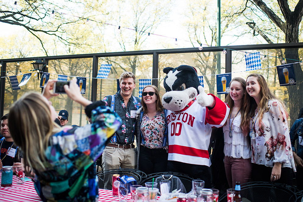 Student taking selfies with mascot Rhett