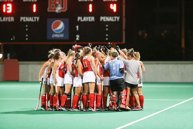 The 2017 BU field hockey team huddles during a game