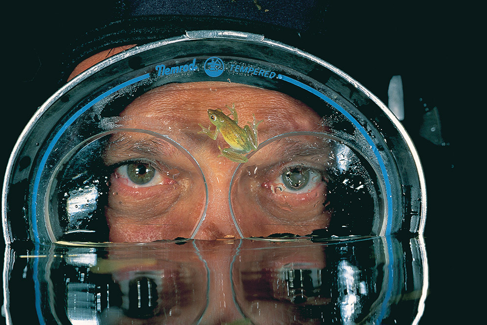 David Doubilet with reed frog on his mask while on assignment Okavango Delta Botswana