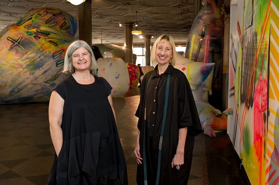 Claire Ashley and Lynne Cooney, artistic director of the BU Art Galleries, at the opening of the Crazy Female Foreigners Alive and Kicking exhibit at 808 Gallery