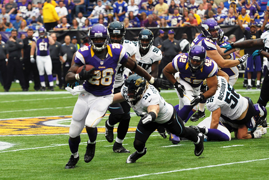 The Minnesota Vikings break through the Detroit Lions line of scrimmage.