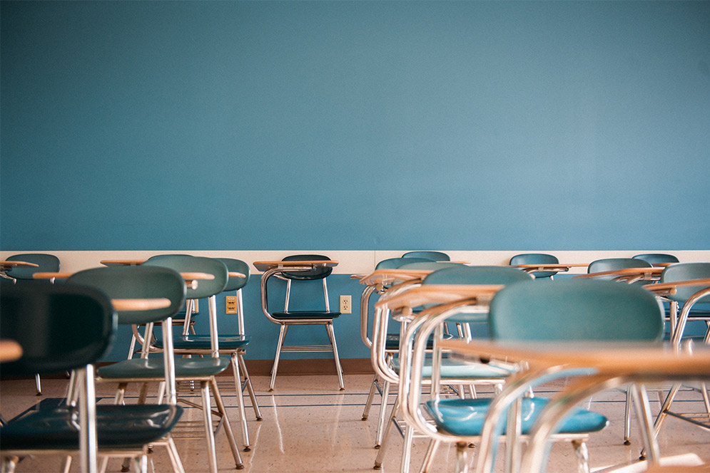 blue chairs and desks in an empty classroom