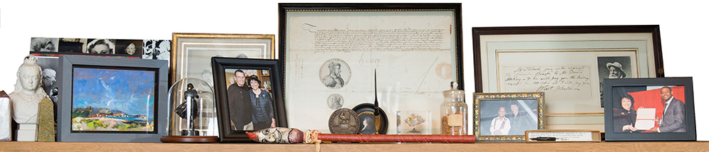 A shelf in the office of Vita Paladino, Director and Principal Investigator at the Boston University Howard Gotllieb Archival Research Center, containing artifacts from the Center's collections.