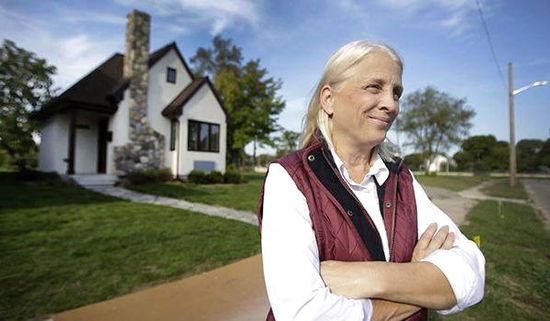 Faith Fowler stands outside one of her tiny homes in detroit