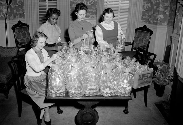 Sorority girls put together Easter baskets.