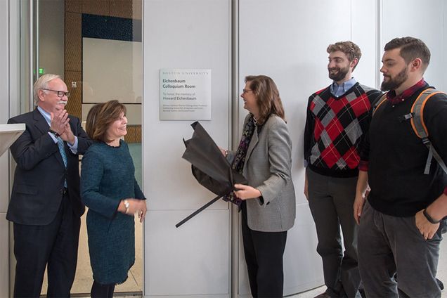 BU President President Robert A Brown, Gloria Waters, and the family of Howard Eichenbaum unveil the sign dedicating the Kilachand Center colloquium room to Eichenbaum's memory.