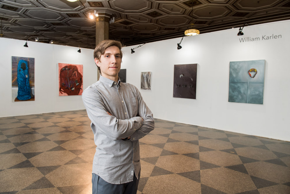 William Karlen (CFA’18) with several of his paintings.