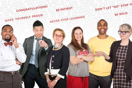 Boston University faculty and staff stand in front of words of advice for the graduating Class of 2018