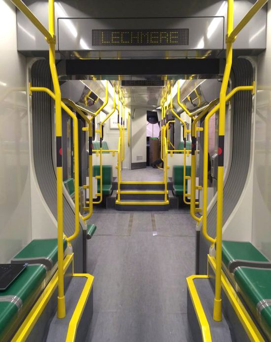 The empty inside of a new 优先 Green Line car showing seats and extra space