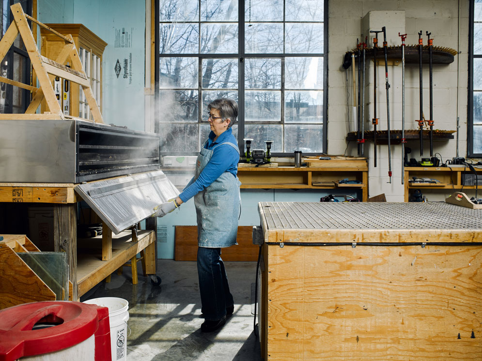 Allison Hardy using pressurized steam to soften old paint