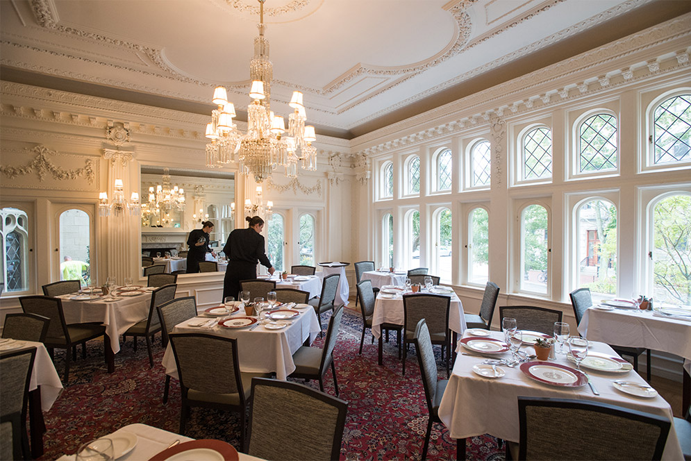 A waitress sets the tables in the dining room of the Dahod Family Alumni Center at Boston University.