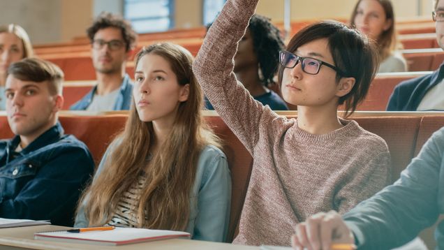 In the Classroom Asian Student Raises Hand and Asks Lecturer a Question. Multi Ethnic Group of Modern Bright Students at the College.