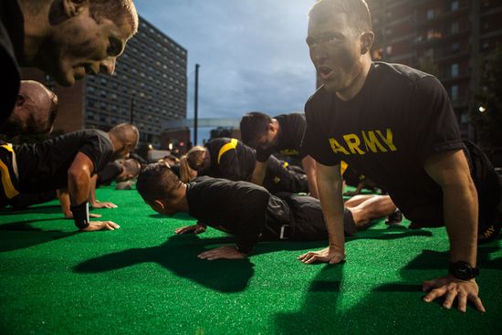 Army ROTC cadets celebrate a touchdown by performing push-ups