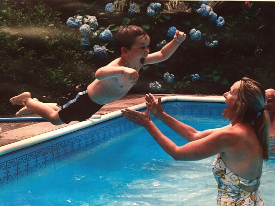 Jesse Lewis jumps into a pool