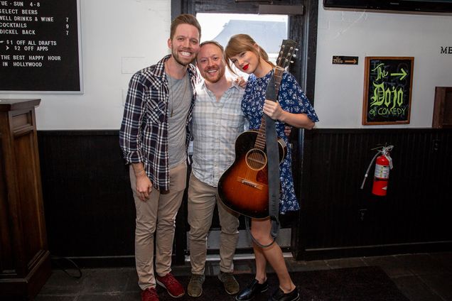 Taylor swift poses with the happy couple