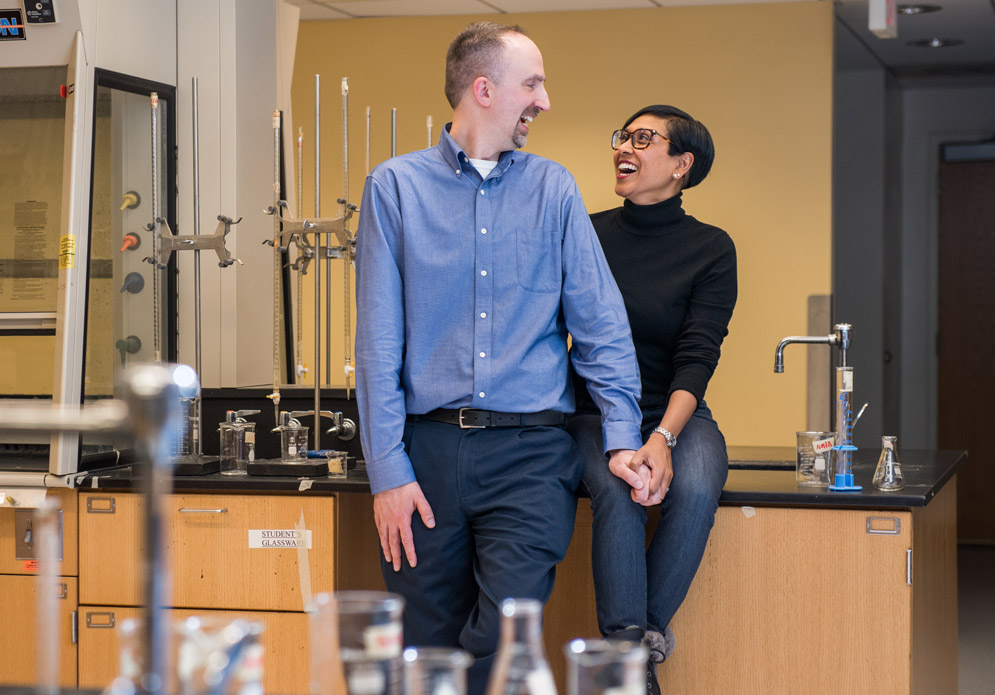 Kevin Hallock and Sushma Devi Agam Hallock gaze into each other's eyes in the chemistry lab.