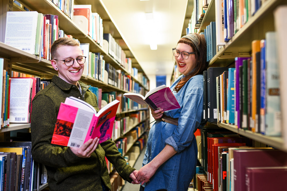 Ever Hanna (COM’12) and Ariana Katz (CAS’12) pose amoung library shelves