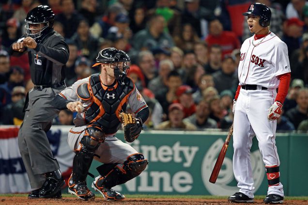 The Red Sox's Mookie Betts (right) is in disbelief as homeplate umpire C.B. Bucknor (left) calls him out on strikes.