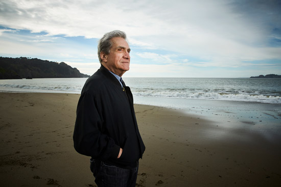 Robert Pinsky standing on a beach