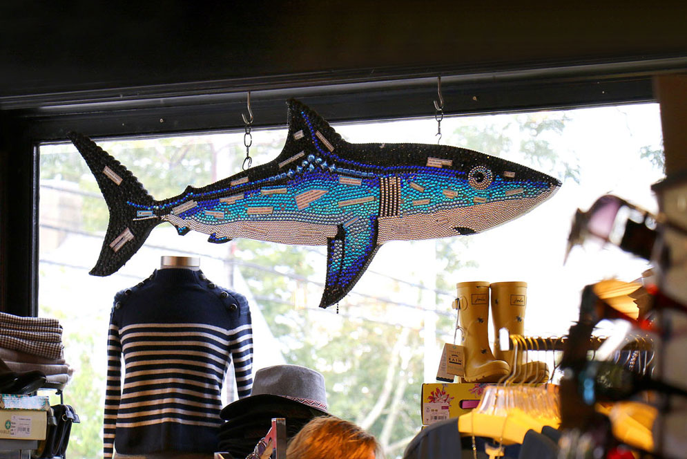 A BU expert suggests businesses avoid “shark tourism,” like this artwork in a Chatam store in 2017, after last summer’s tragedy. Photo by John Tlumacki/The Boston Globe via Getty Images