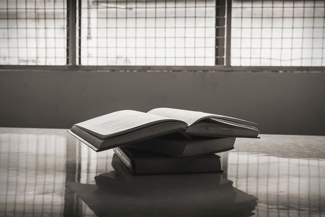 Stack of books on a table in a prison