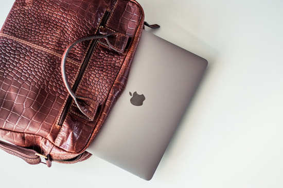 professional bag with Apple MacBook Pro sliding out.