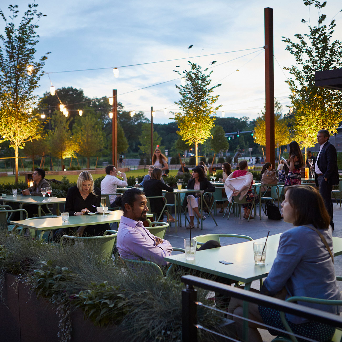 Customers dine at twilight on the patio of Time Out Market, Boston