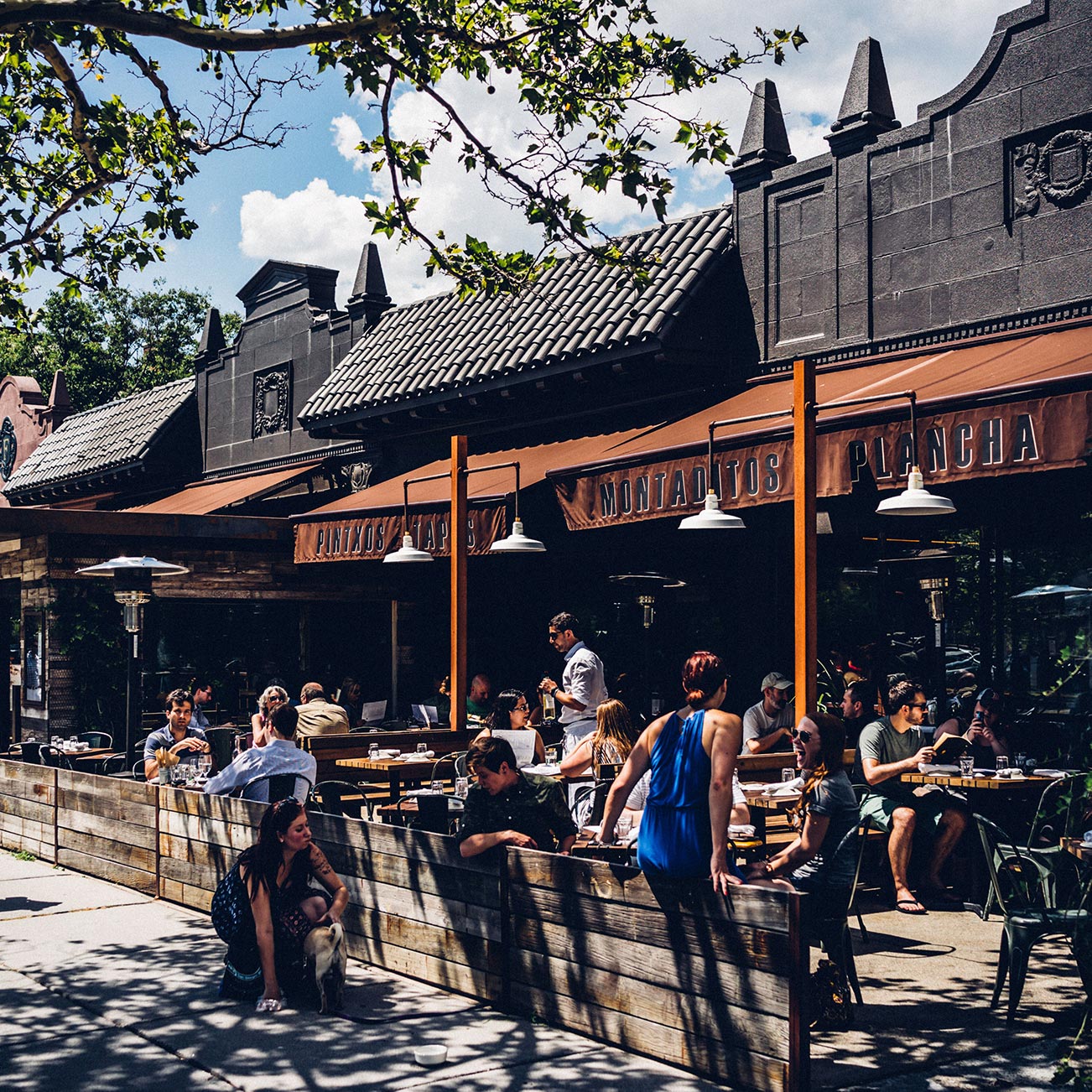 Customers dine in the sunshine on the Barcelona Wine Bar outdoor patio.